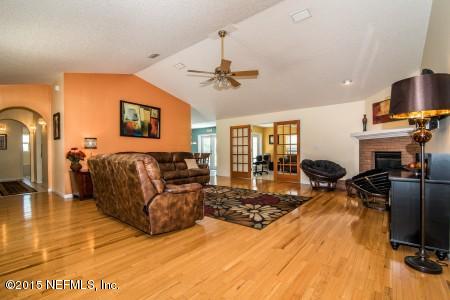 1930 Forbes Road St. Augustine, FL 32092 - Photo 10 of 24 a living room with fireplace furniture and a flat screen tv