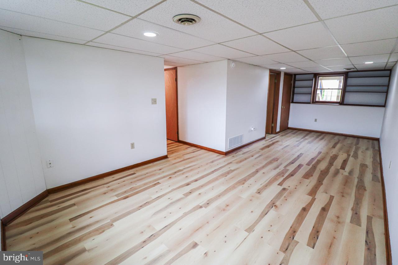 614 Eichelberger Street Hanover, PA 17331 - Photo 21 of 36 a view of an empty room with wooden floor and a window