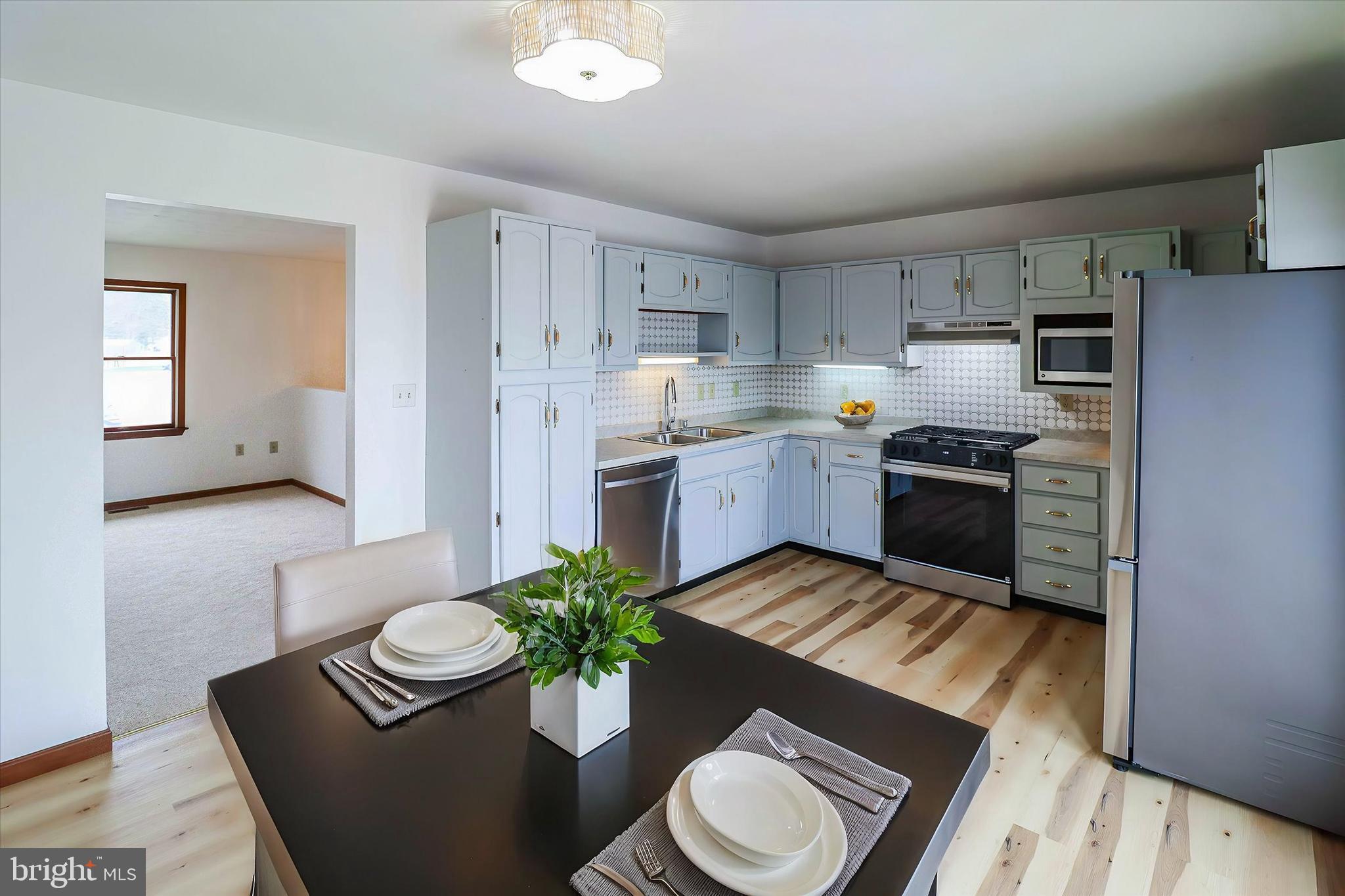 614 Eichelberger Street Hanover, PA 17331 - Photo 6 of 36 a kitchen with sink refrigerator dining table and chairs