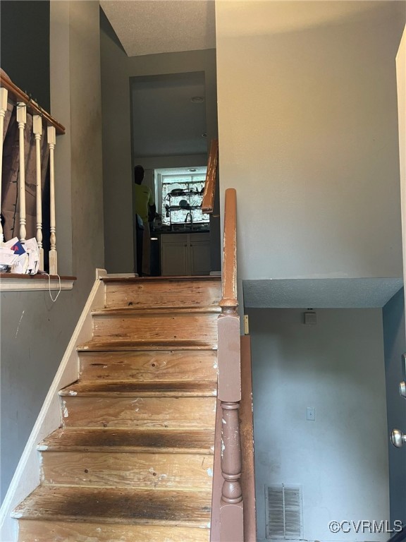 10131 Ridgerun Road Chesterfield, VA 23832 - Photo 3 of 18 a view of staircase with white walls and railing