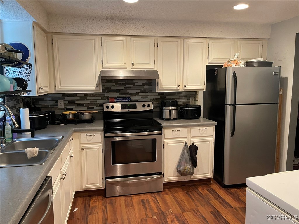 10131 Ridgerun Road Chesterfield, VA 23832 - Photo 5 of 18 a kitchen with a refrigerator stove and white cabinets