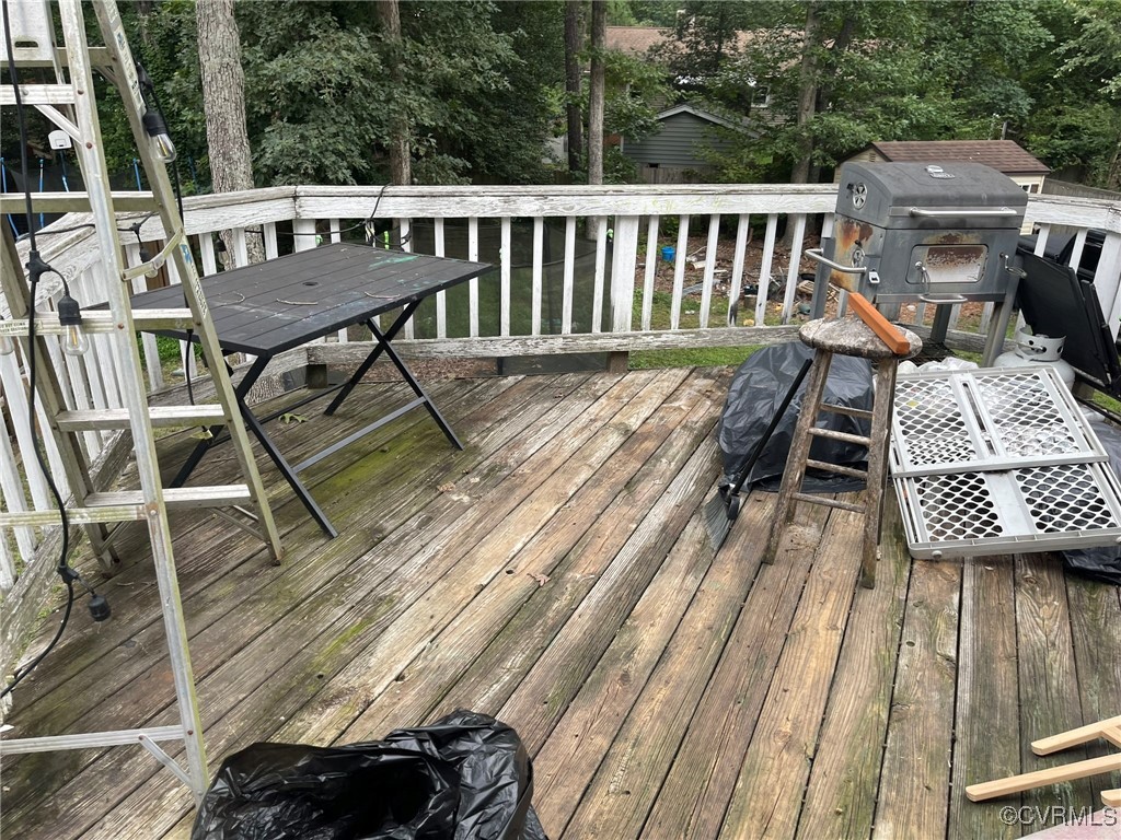 10131 Ridgerun Road Chesterfield, VA 23832 - Photo 6 of 18 a view of a roof deck with table and chairs a barbeque with wooden floor and fence