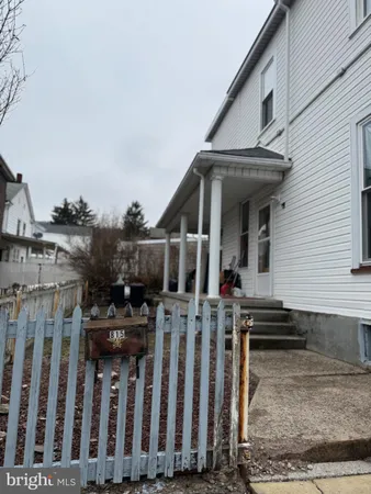 a view of a house with wooden fence