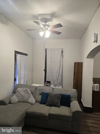 a living room with furniture and a mirror