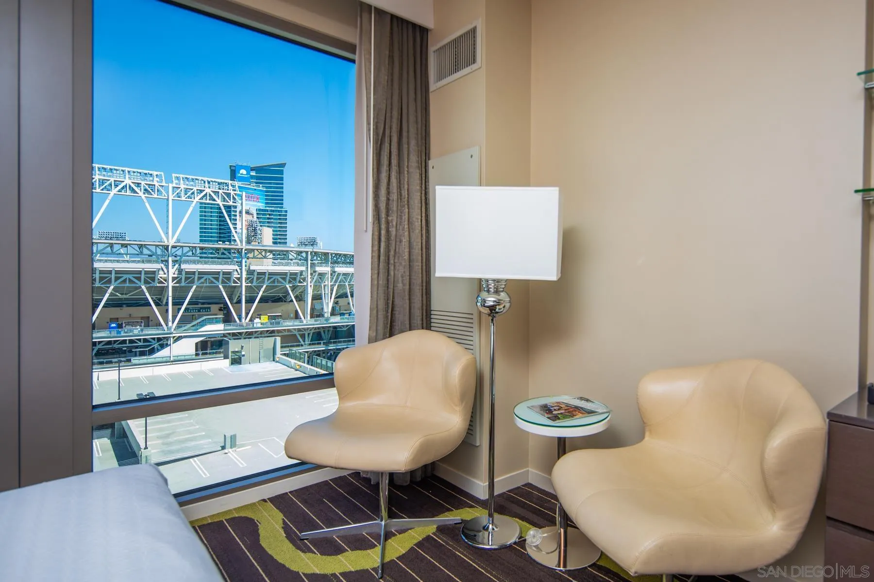 207 Fifth Avenue, Unit 1224 San Diego, CA 92101 - Photo 2 of 15 a living room with furniture and a chair
