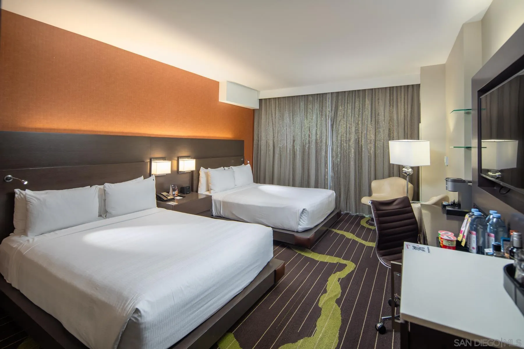 207 Fifth Avenue, Unit 1224 San Diego, CA 92101 - Photo 10 of 15 a bedroom with a bed and a flat screen tv