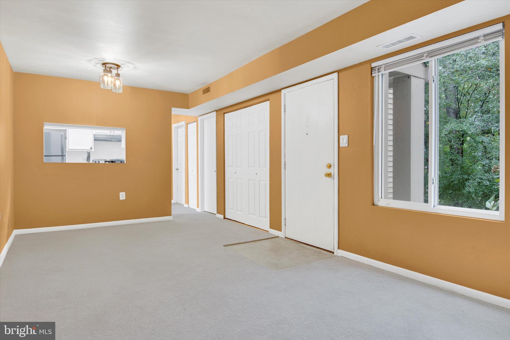 10310 Rein Commons Court, Unit 1B Burke, VA 22015 - Photo 10 of 23 a view of an empty room with a window