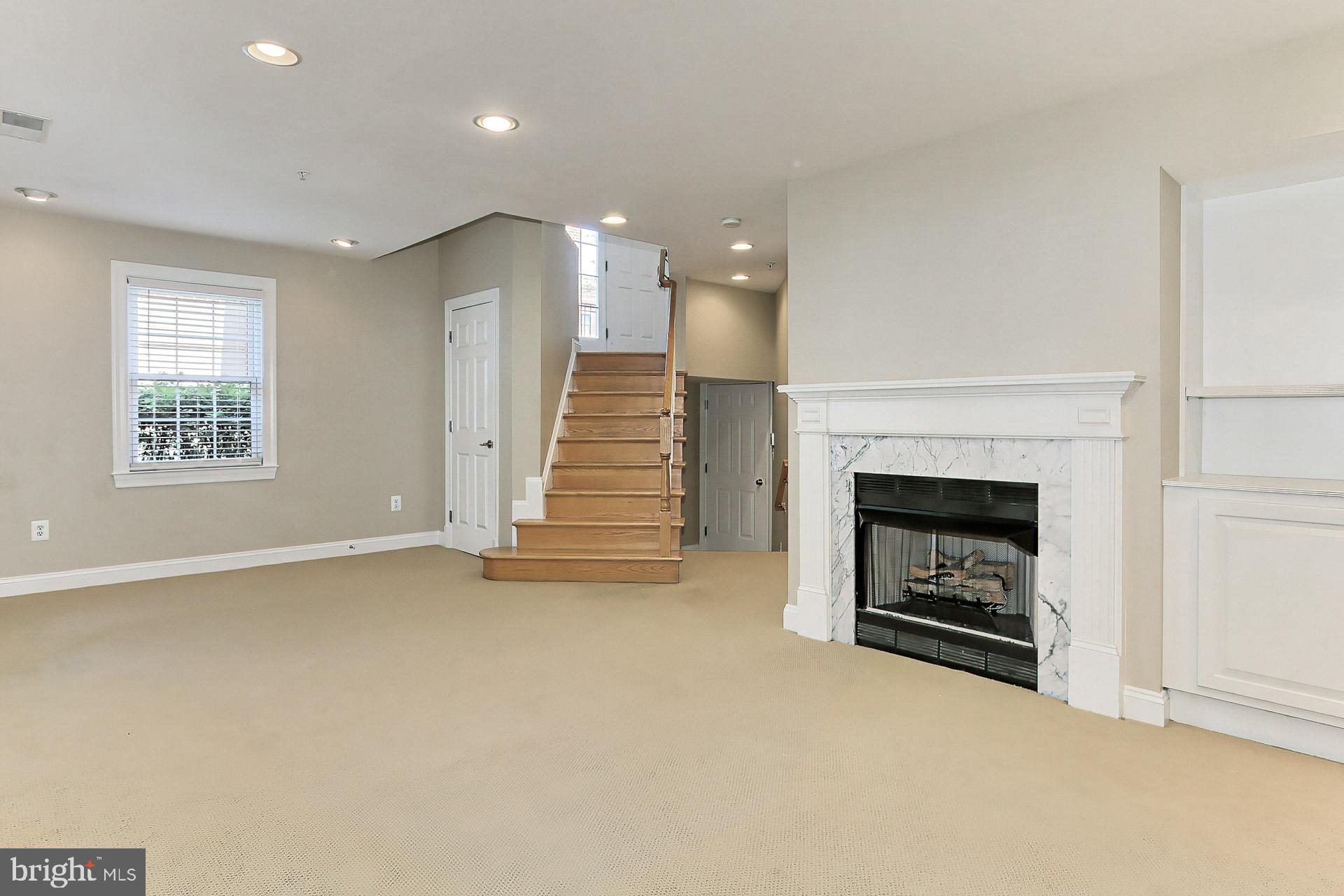 12131 Chancery Station Circle Reston, VA 20190 - Photo 52 of 66 Lpwer level fireplace and book shelves