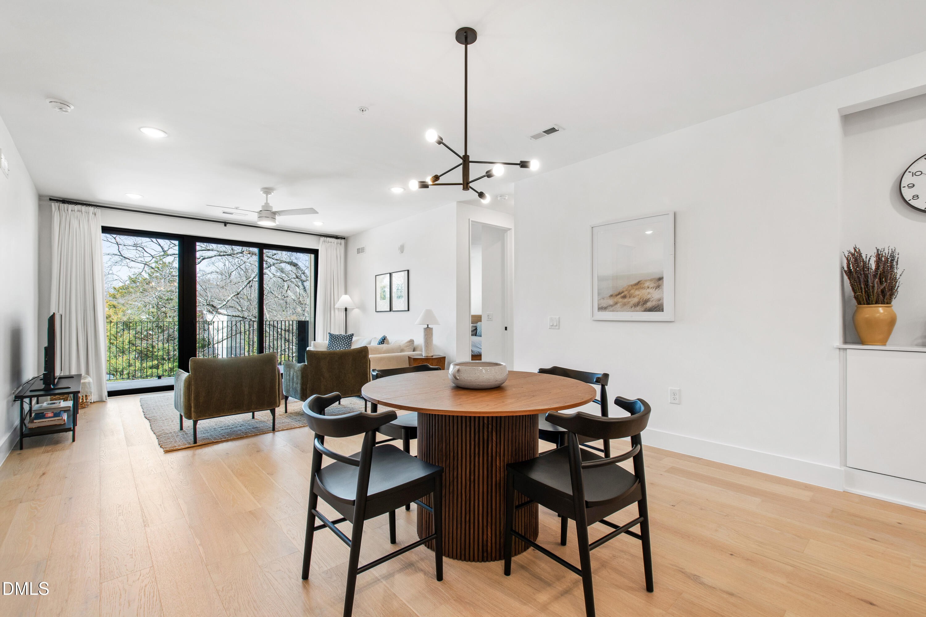 29 Enterprise Street, Unit 211 Raleigh, NC 27607 - Photo 15 of 48 a dining room with furniture a chandelier and wooden floor