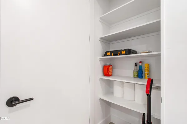 a hallway with white cabinets