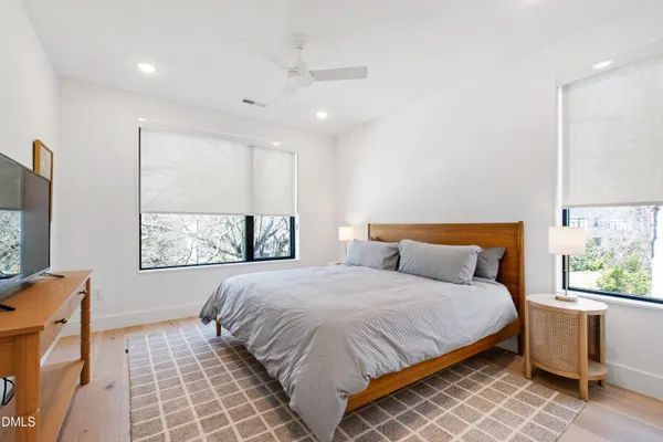 a bedroom with a large bed and a window