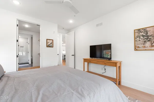 a bedroom with a bed and a flat screen tv
