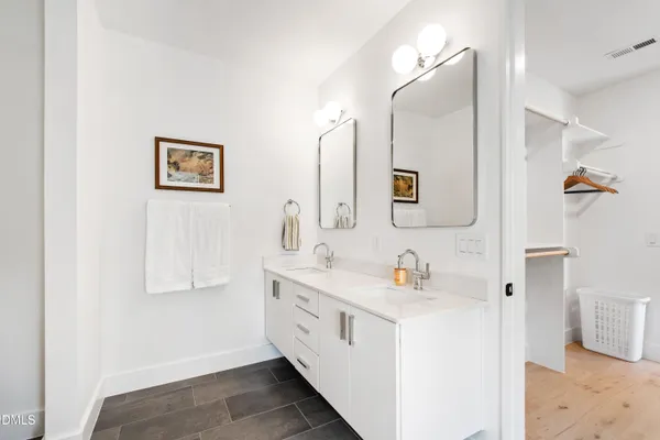 a bathroom with a double vanity sink mirror and