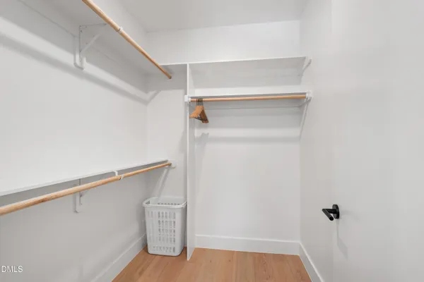 a view of walk in closet with empty racks