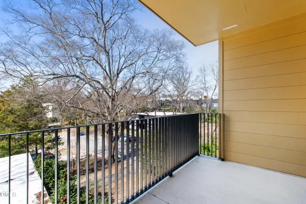 a view of a gate and trees from a terrace