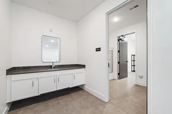 a bathroom with a double vanity sink and mirror
