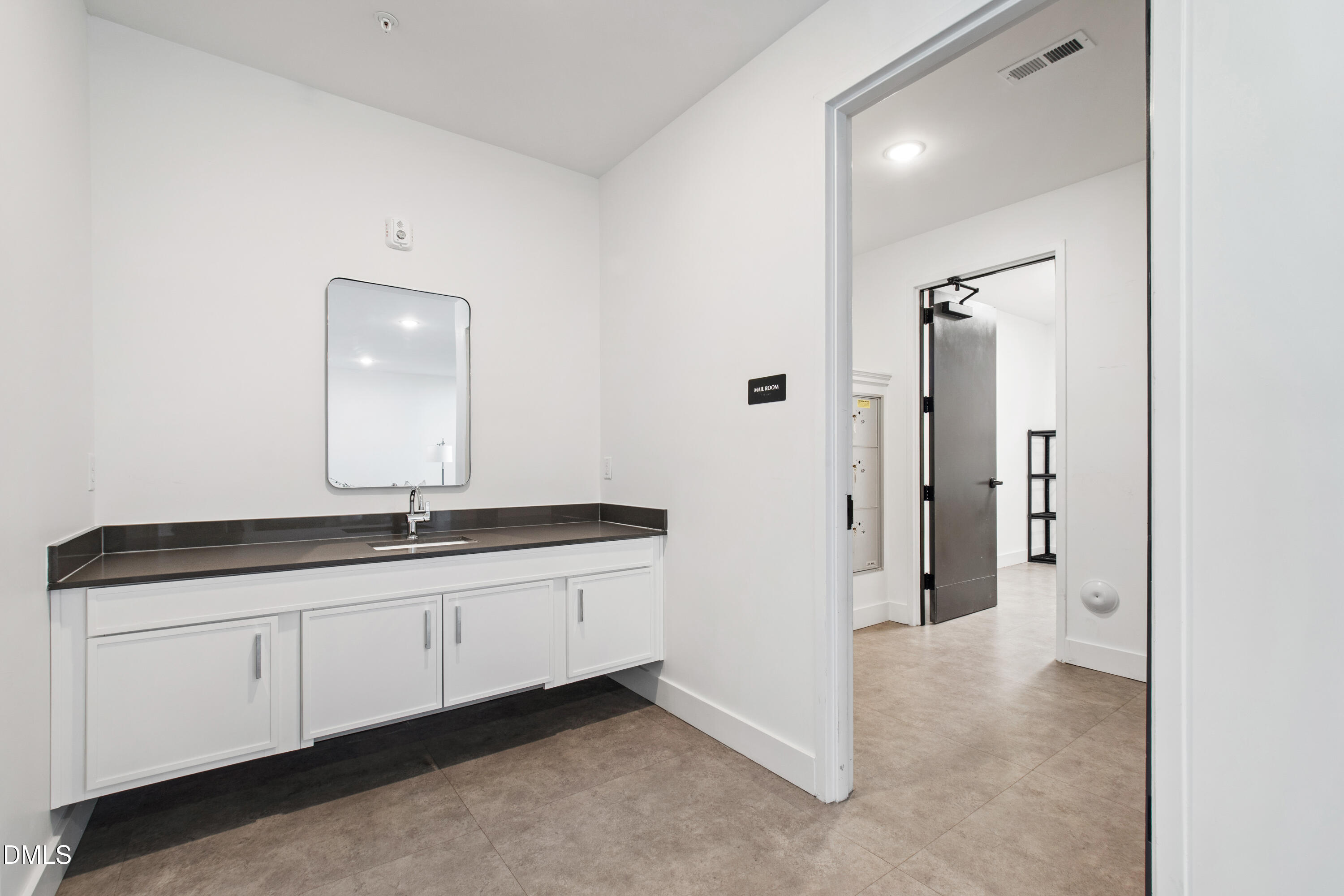 29 Enterprise Street, Unit 211 Raleigh, NC 27607 - Photo 41 of 48 a bathroom with a double vanity sink and mirror