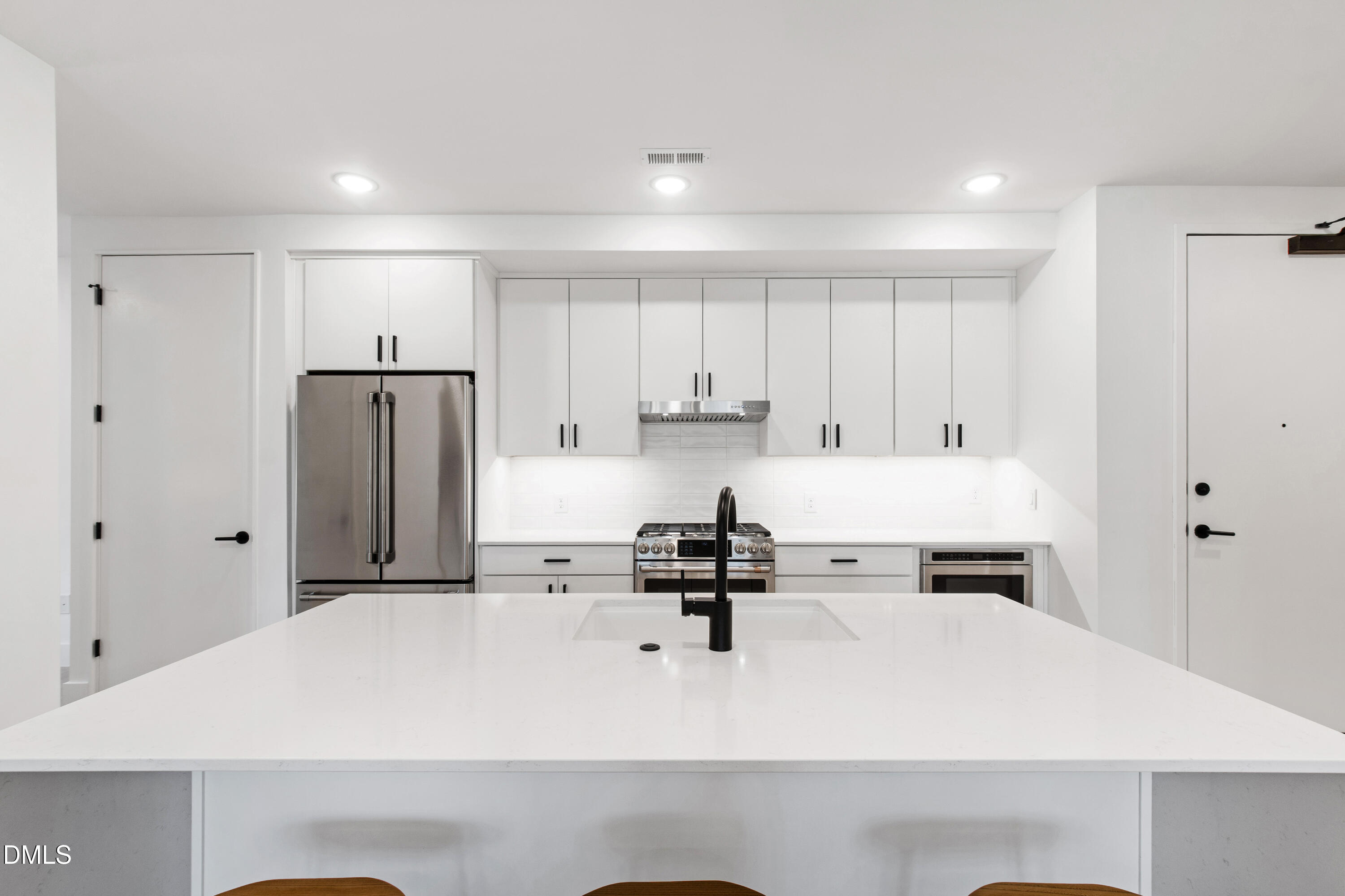 29 Enterprise Street, Unit 211 Raleigh, NC 27607 - Photo 9 of 48 a kitchen with stainless steel appliances a refrigerator sink and cabinets