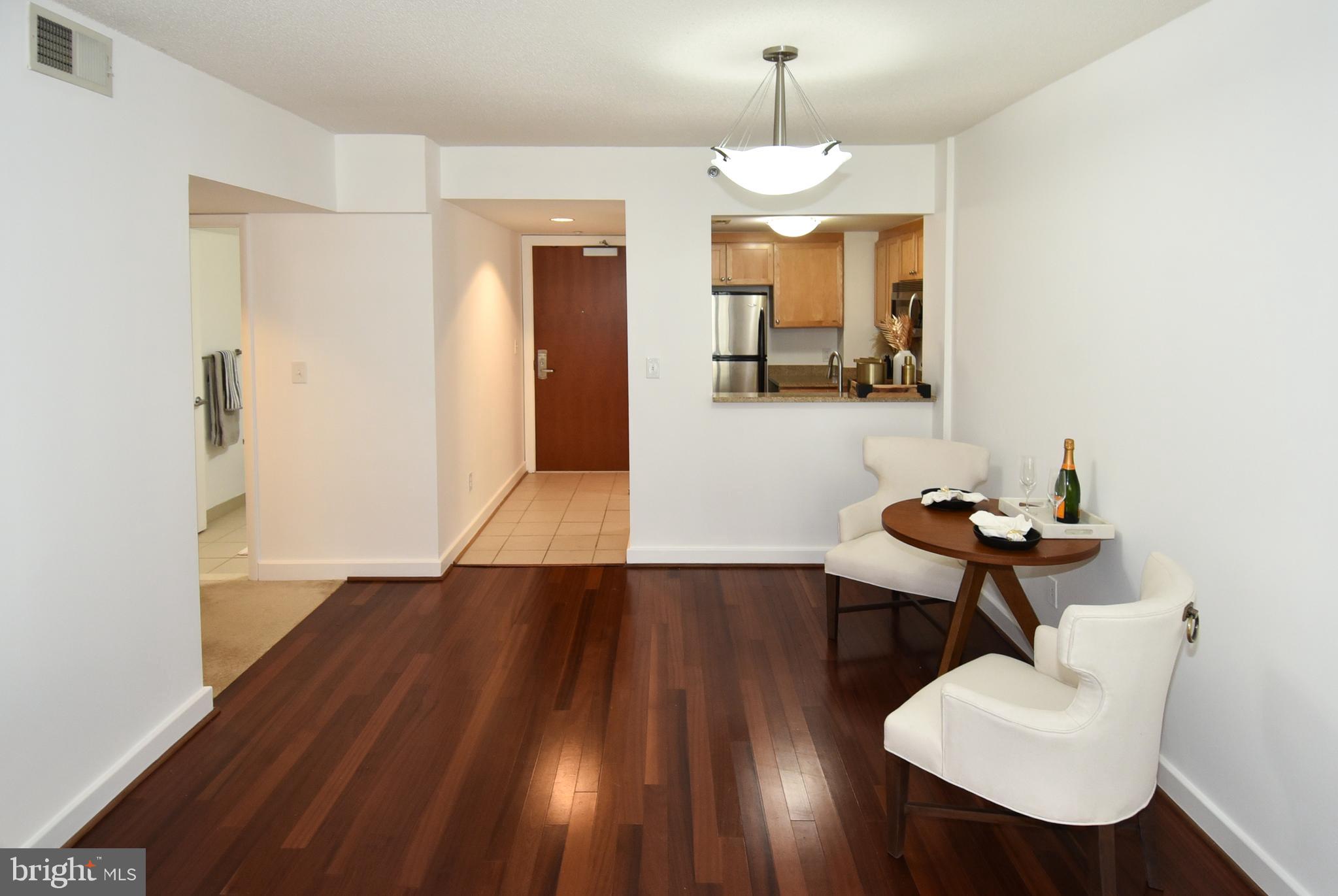 1150 K Street Northwest, Unit 408 Washington, DC 20005 - Photo 12 of 32 a view of a hallway with furniture and wooden floor