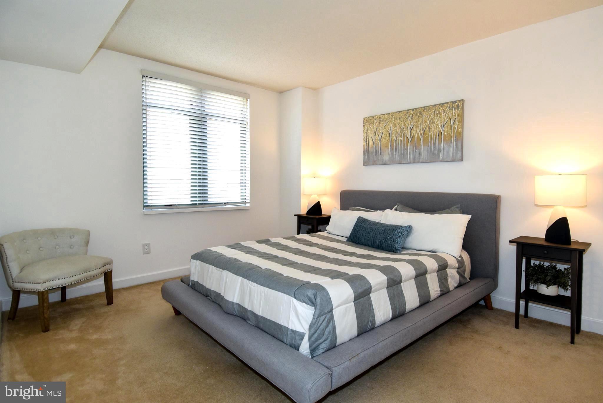 1150 K Street Northwest, Unit 408 Washington, DC 20005 - Photo 17 of 32 a bedroom with bed and a window