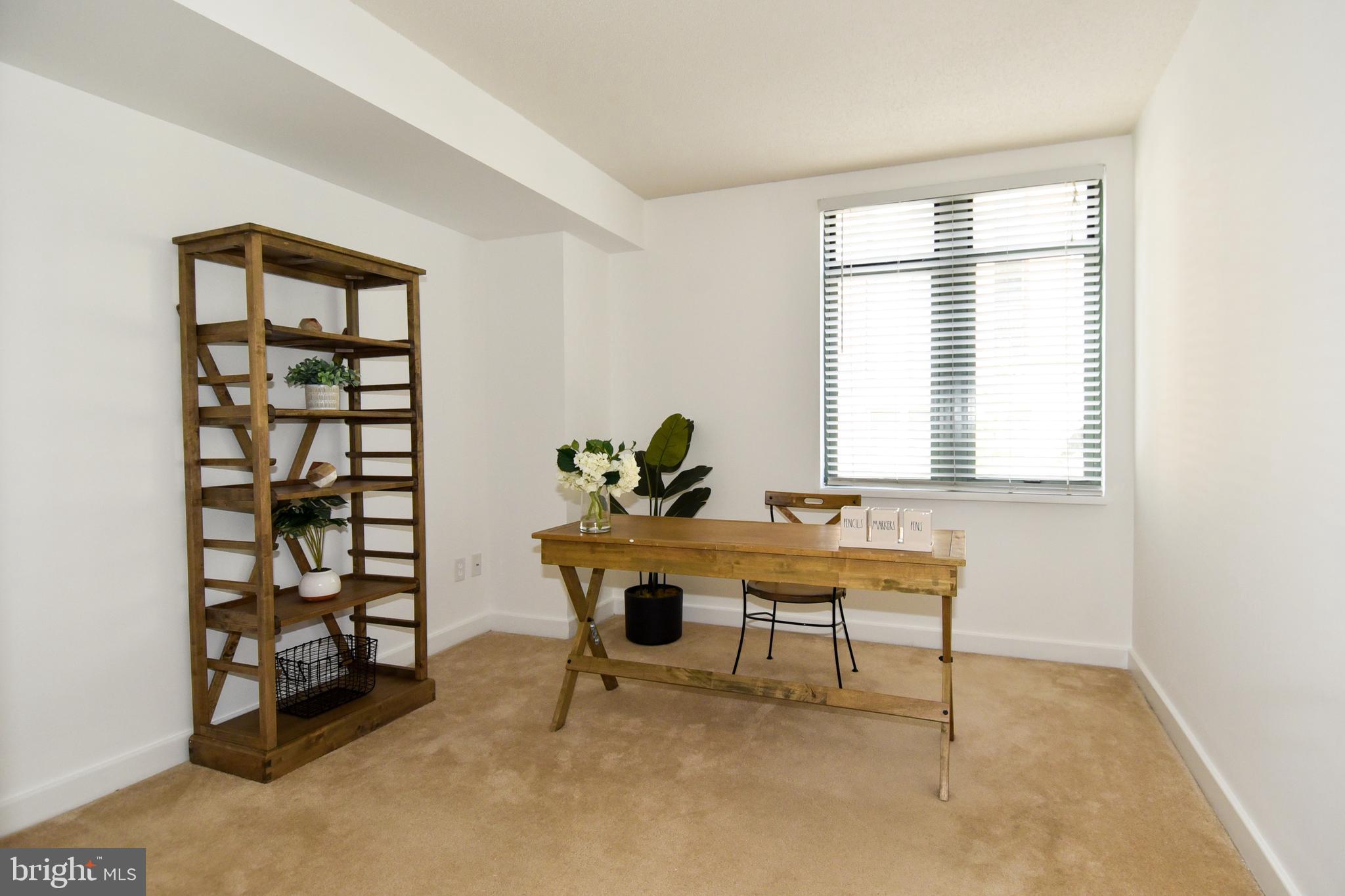 1150 K Street Northwest, Unit 408 Washington, DC 20005 - Photo 20 of 32 a view of a workspace with furniture and a window