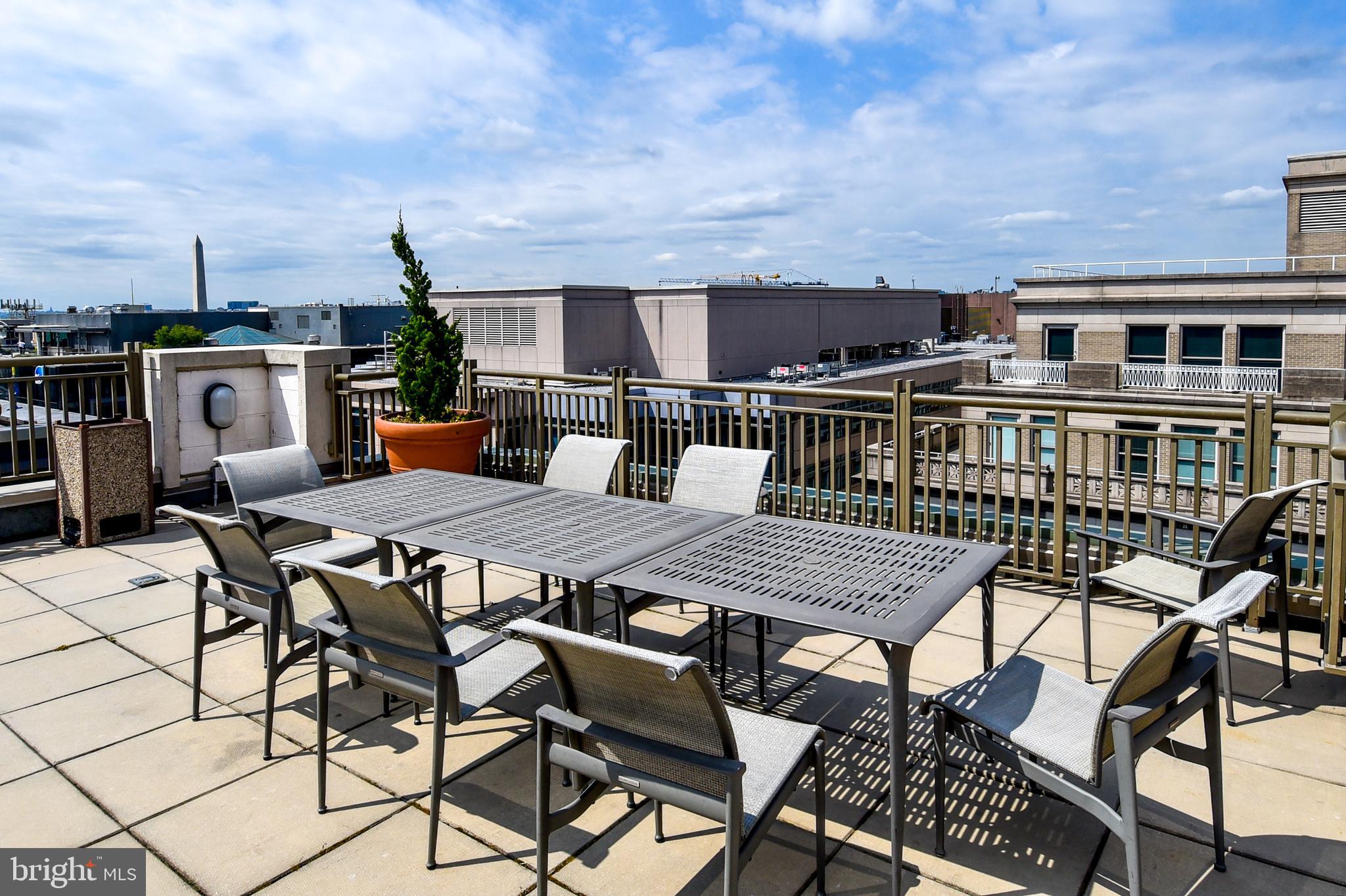 1150 K Street Northwest, Unit 408 Washington, DC 20005 - Photo 27 of 32 a roof deck with a table and chairs