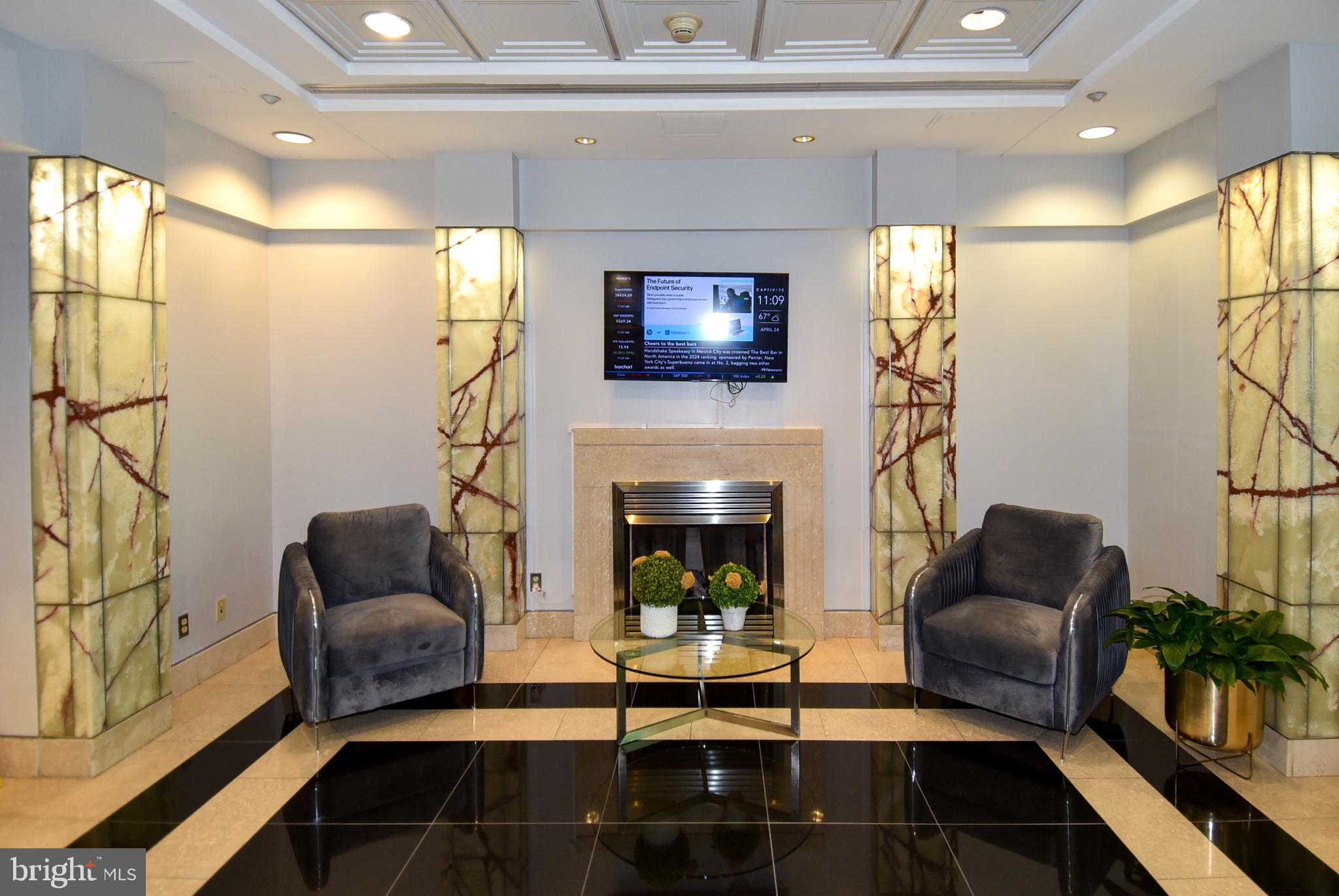 1150 K Street Northwest, Unit 408 Washington, DC 20005 - Photo 4 of 32 a living room with furniture and a fireplace