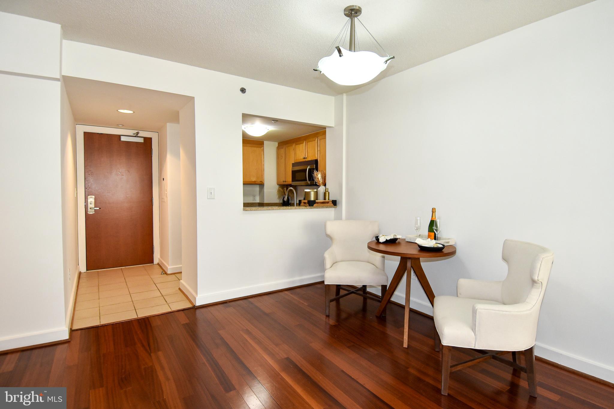 1150 K Street Northwest, Unit 408 Washington, DC 20005 - Photo 6 of 32 a view of a room with breakfast area and wooden floor