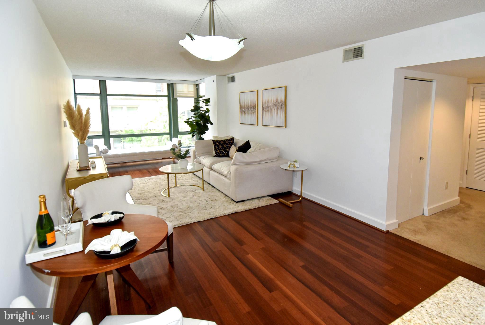 1150 K Street Northwest, Unit 408 Washington, DC 20005 - Photo 7 of 32 a living room with furniture and a large window