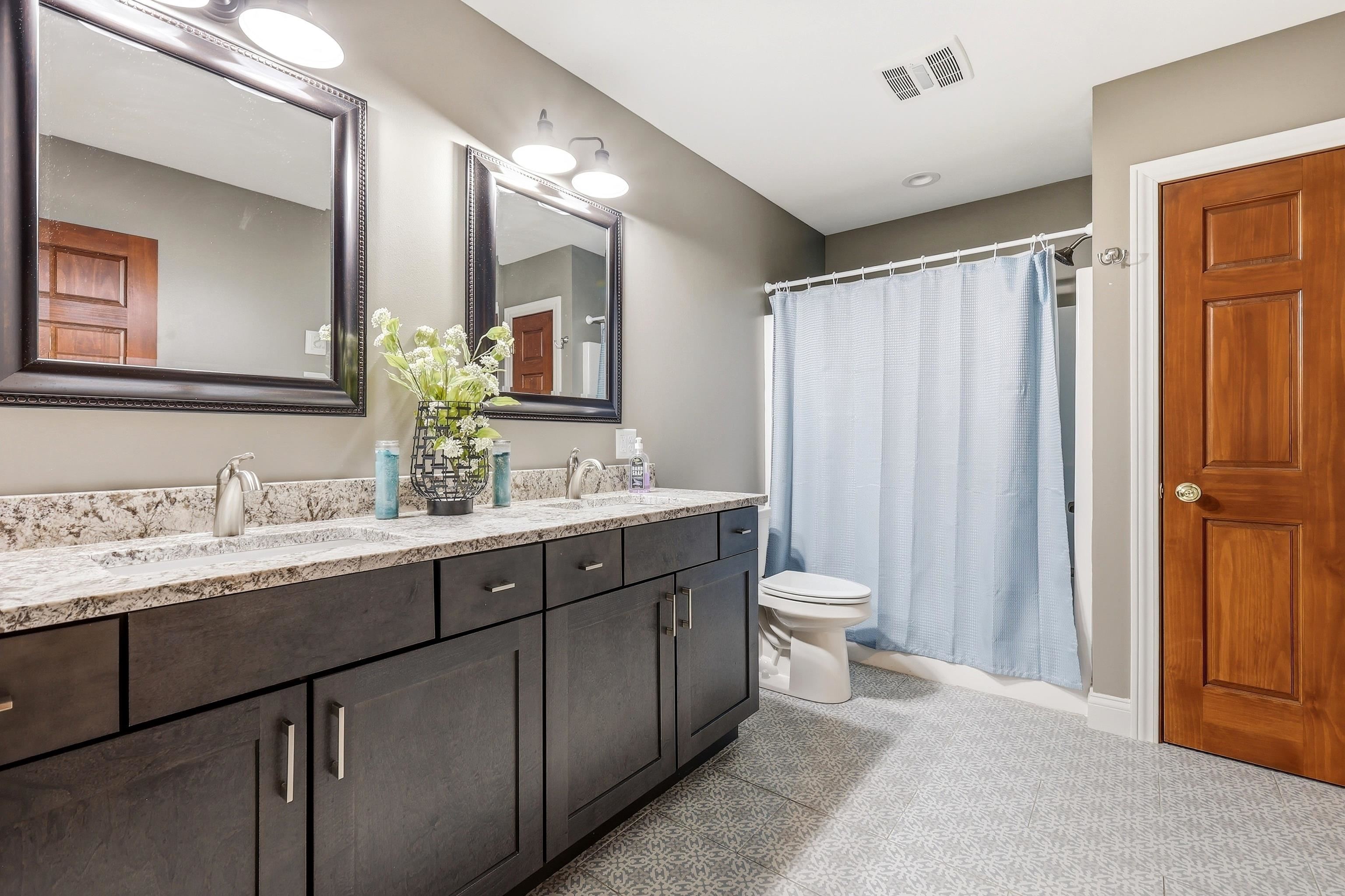 6603 West Council Hill Road Scales Mound, IL 61075 - Photo 26 of 49 a bathroom with a double vanity sink toilet and a mirror