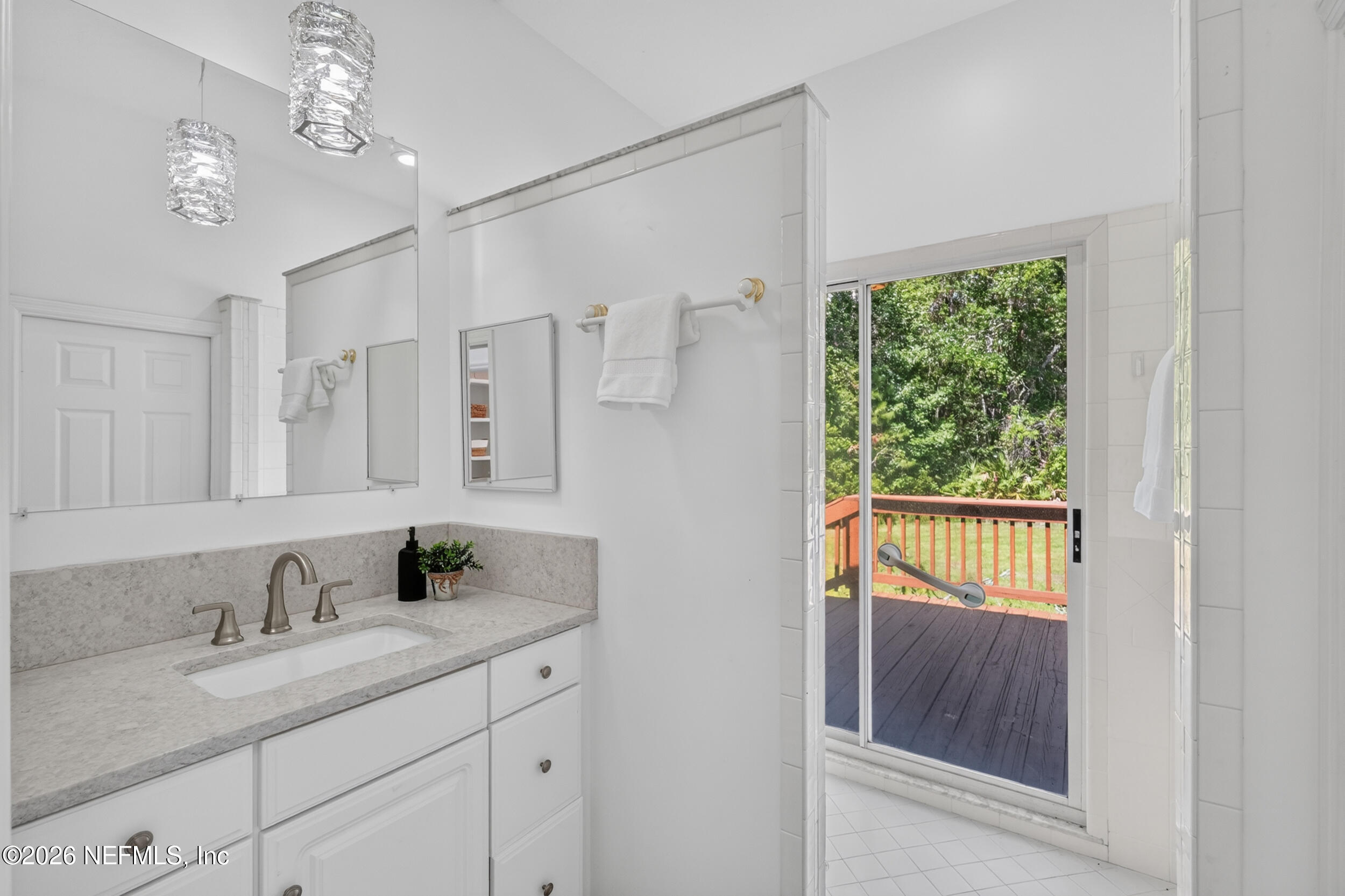 3090 Monument Bay Road St. Augustine, FL 32092 - Photo 29 of 56 a en suite bathroom with a granite countertop sink a mirror and shower