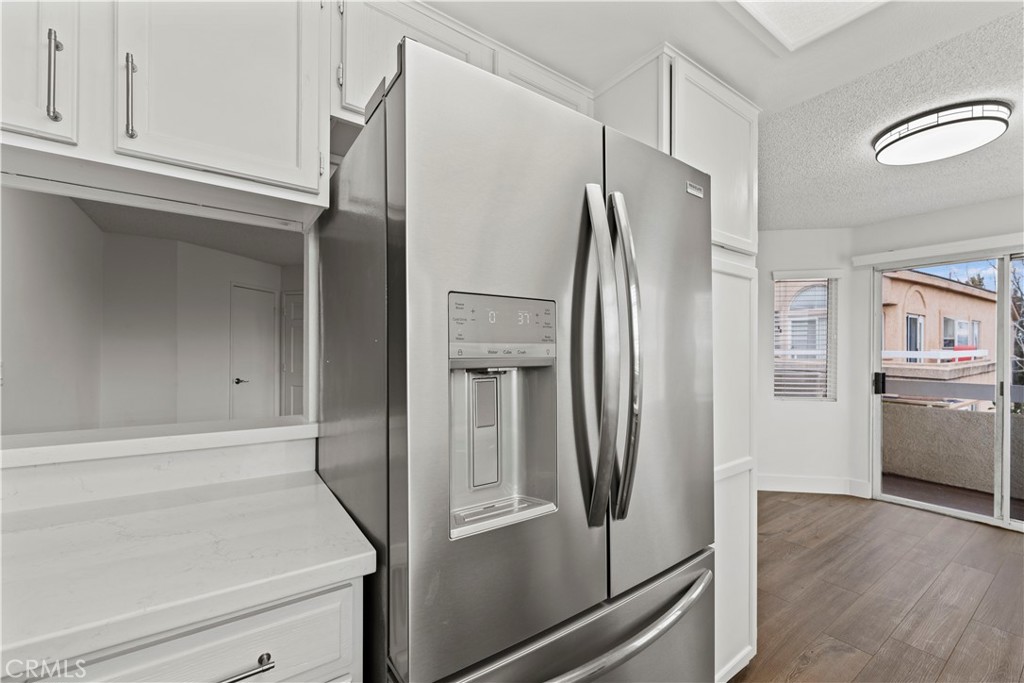 19847 Sandpiper Place, Unit 139 Newhall, CA 91321 - Photo 20 of 50 a metallic refrigerator freezer sitting in a kitchen