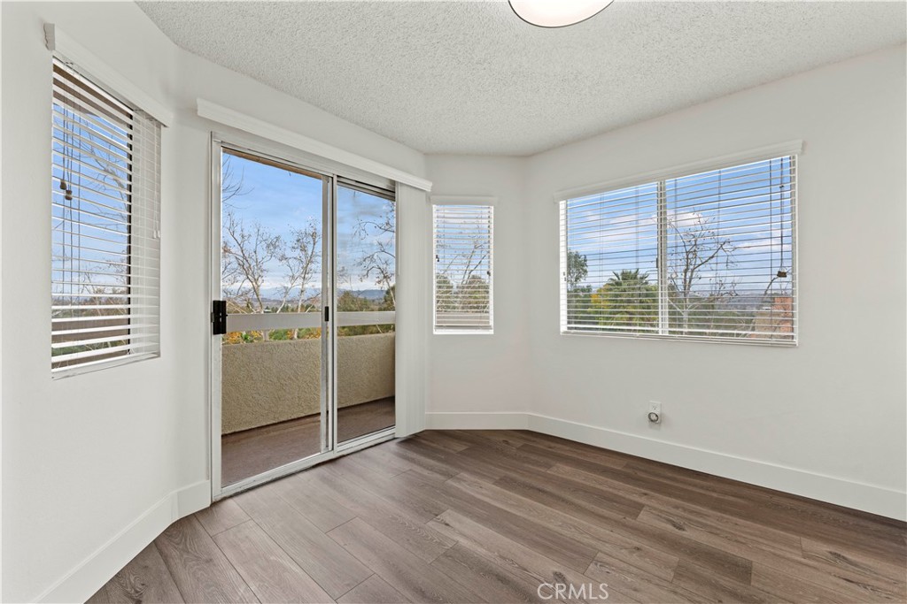 19847 Sandpiper Place, Unit 139 Newhall, CA 91321 - Photo 27 of 50 a view of a kitchen with wooden floor and electronic appliances