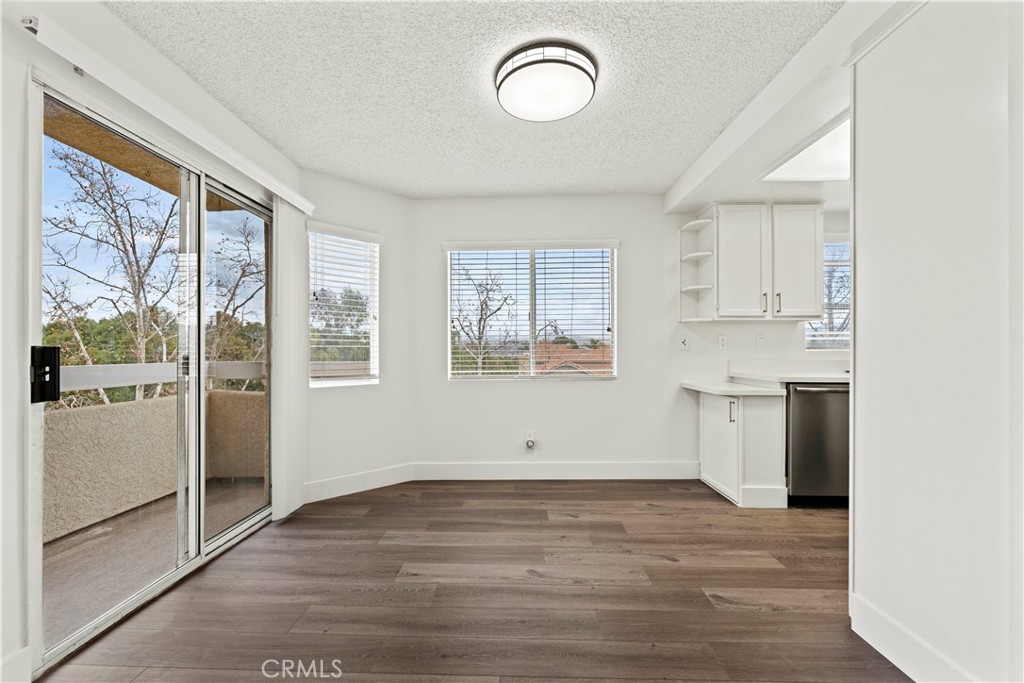 19847 Sandpiper Place, Unit 139 Newhall, CA 91321 - Photo 28 of 50 a view of a kitchen with wooden floor and a window