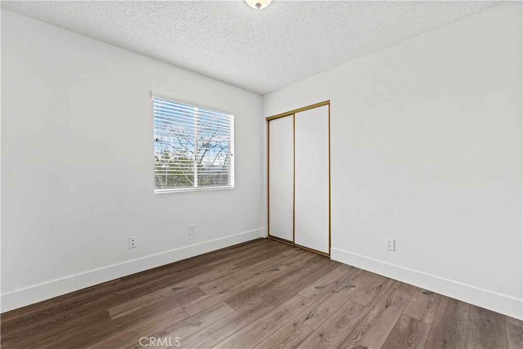 19847 Sandpiper Place, Unit 139 Newhall, CA 91321 - Photo 35 of 50 an empty room with wooden floor and windows
