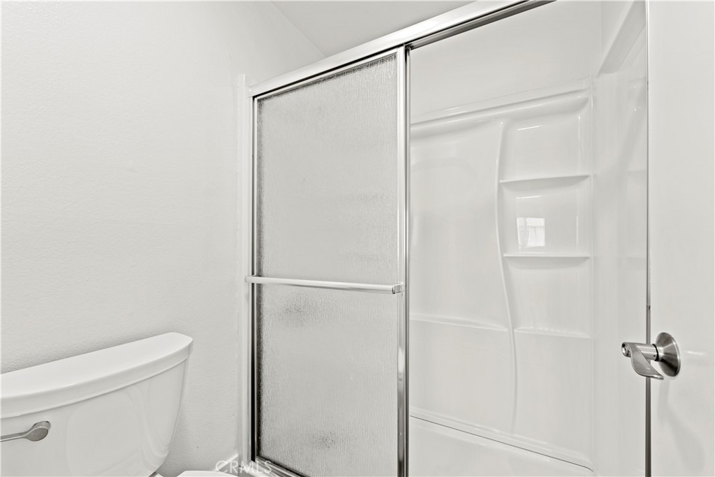 19847 Sandpiper Place, Unit 139 Newhall, CA 91321 - Photo 40 of 50 a bathroom with a shower and a toilet