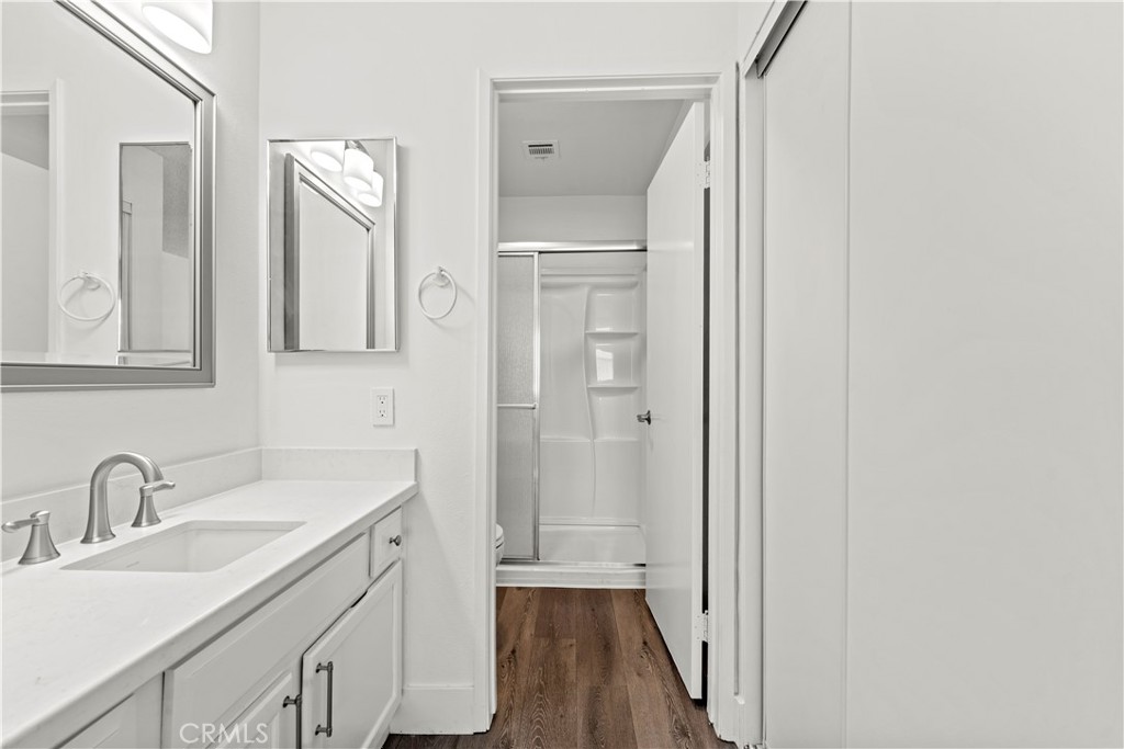 19847 Sandpiper Place, Unit 139 Newhall, CA 91321 - Photo 41 of 50 a bathroom with a sink a mirror and a shower