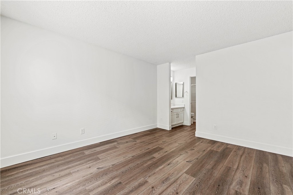 19847 Sandpiper Place, Unit 139 Newhall, CA 91321 - Photo 44 of 50 a view of an empty room with wooden floor and a window