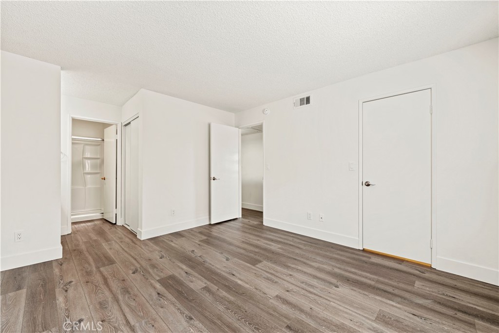 19847 Sandpiper Place, Unit 139 Newhall, CA 91321 - Photo 45 of 50 a view of an empty room with wooden floor