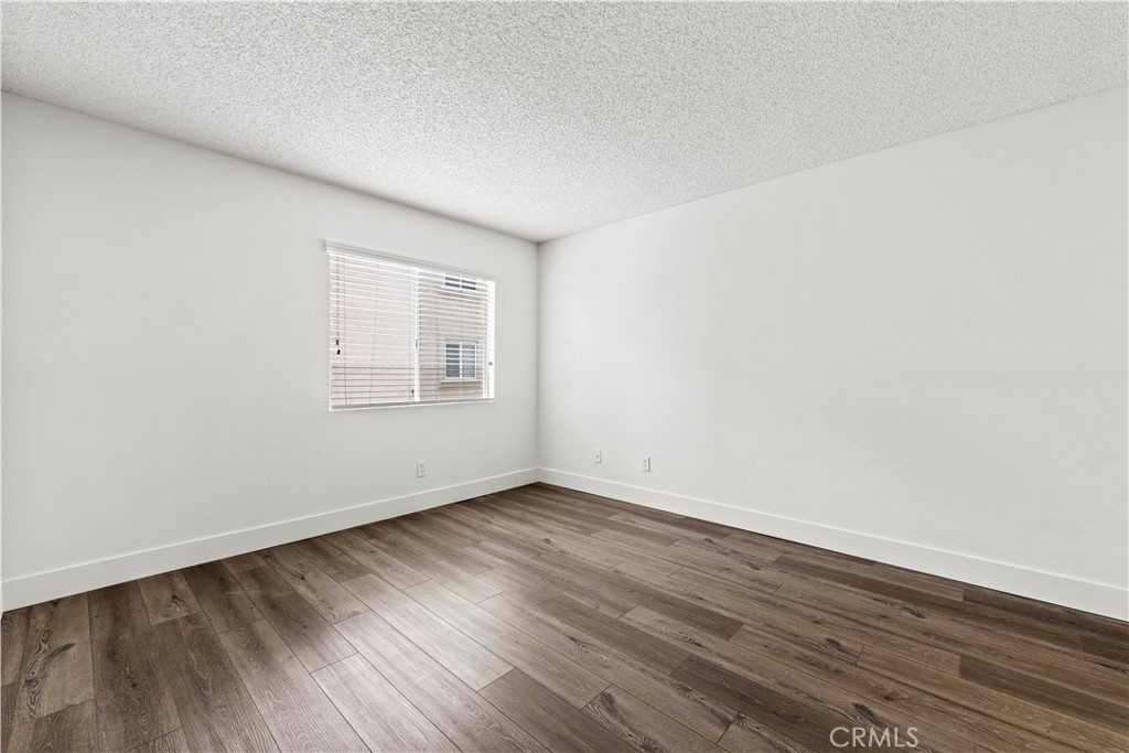 19847 Sandpiper Place, Unit 139 Newhall, CA 91321 - Photo 47 of 50 an empty room with wooden floor and windows