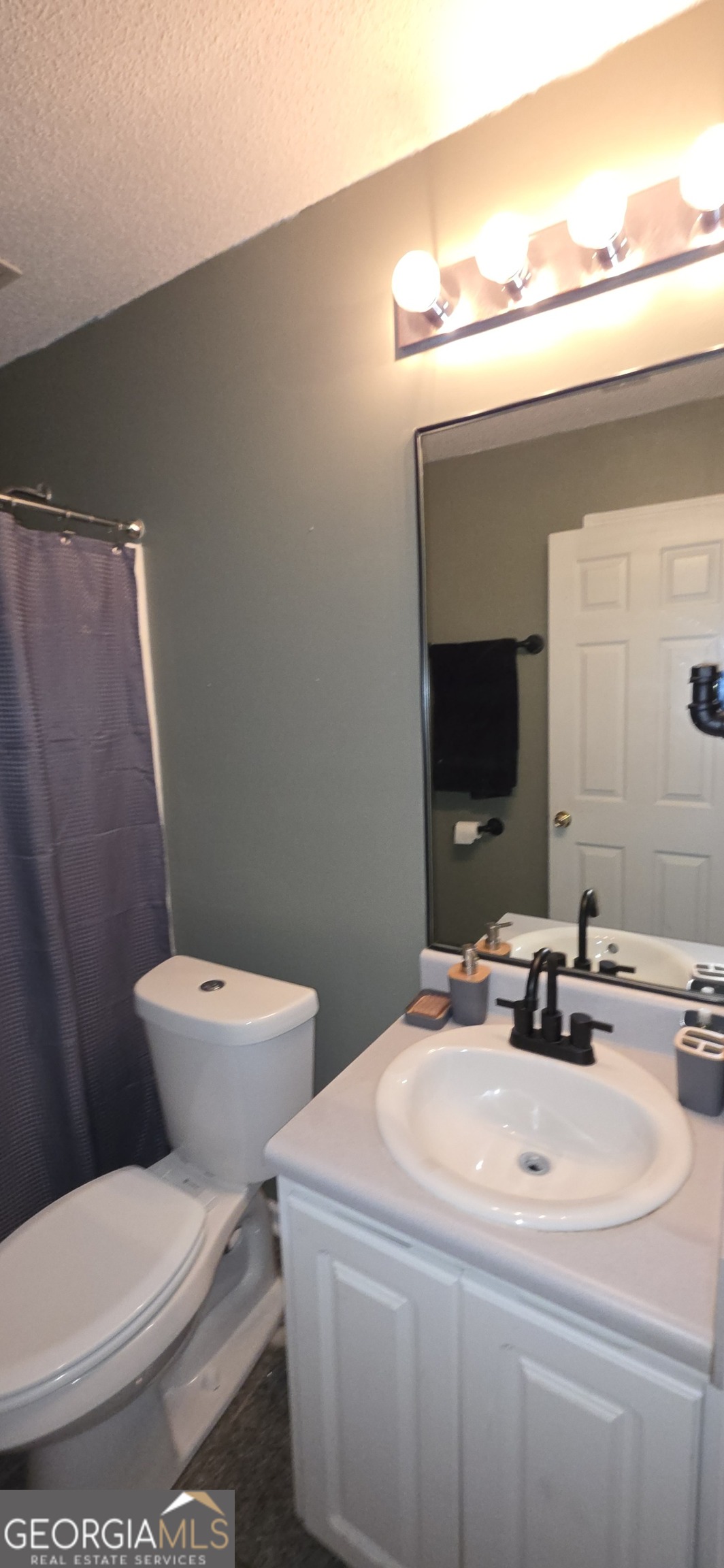 140 Villa Rosa Road Temple, GA 30179 - Photo 15 of 22 a bathroom with a sink a toilet and mirror