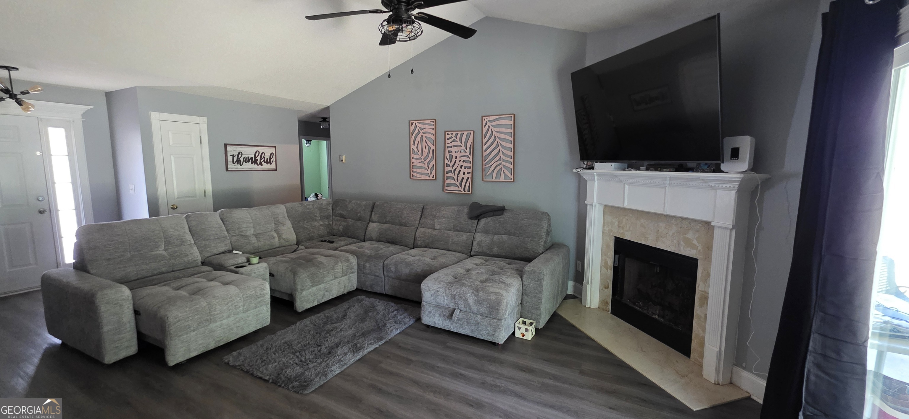 140 Villa Rosa Road Temple, GA 30179 - Photo 5 of 22 a living room with couches a flat screen tv and a fireplace