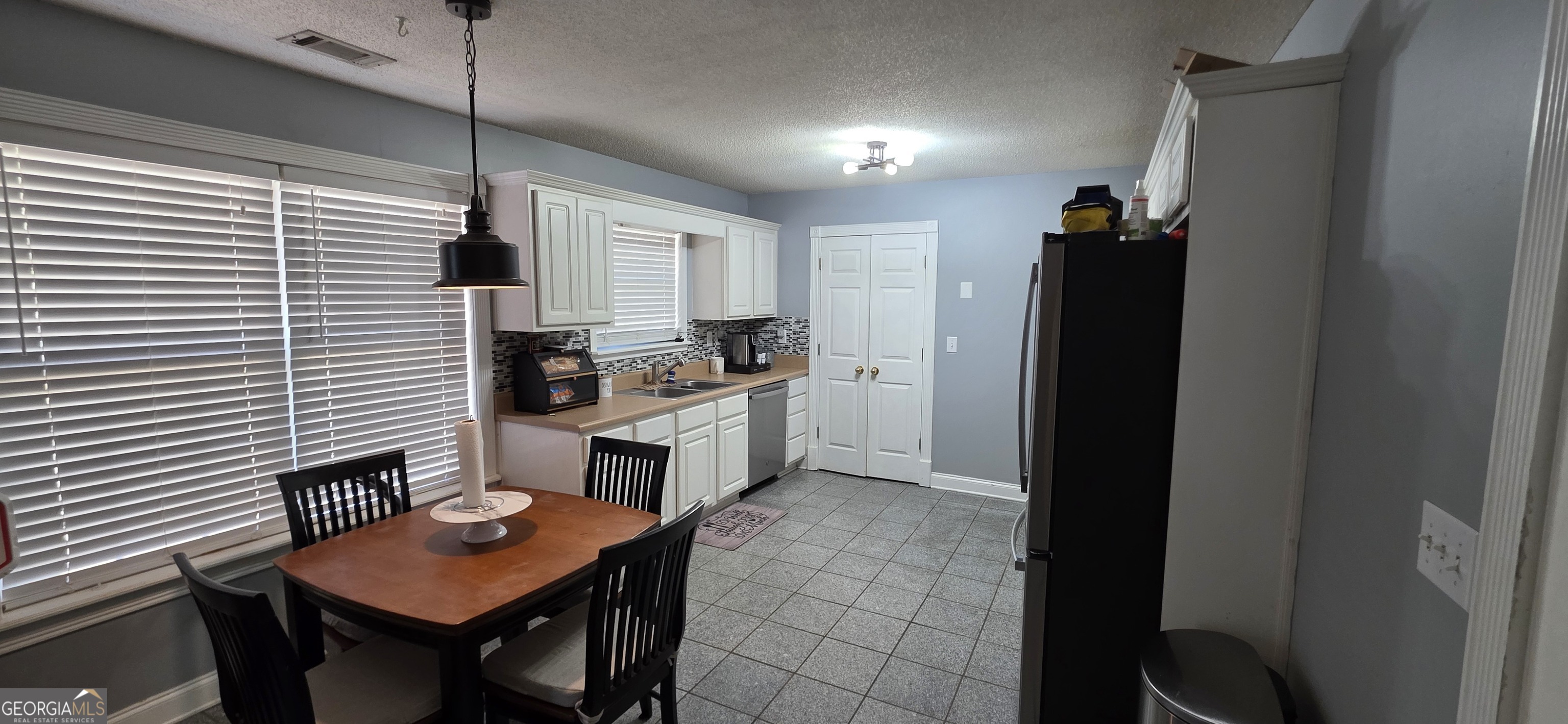 140 Villa Rosa Road Temple, GA 30179 - Photo 6 of 22 a kitchen with refrigerator and chairs