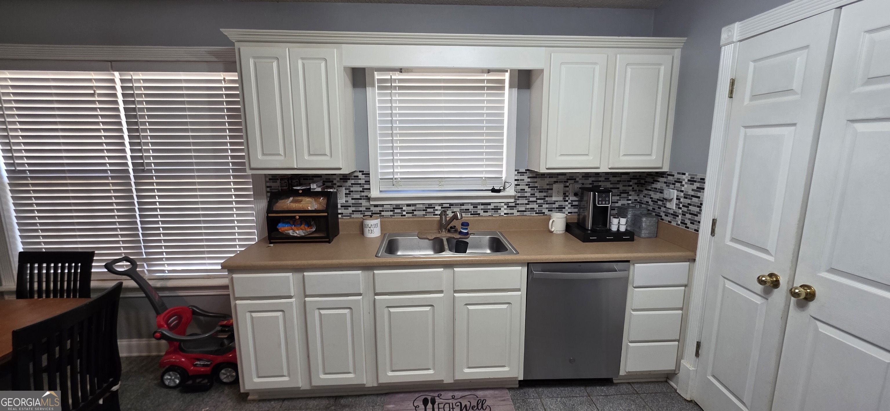 140 Villa Rosa Road Temple, GA 30179 - Photo 7 of 22 a kitchen with white cabinets and window