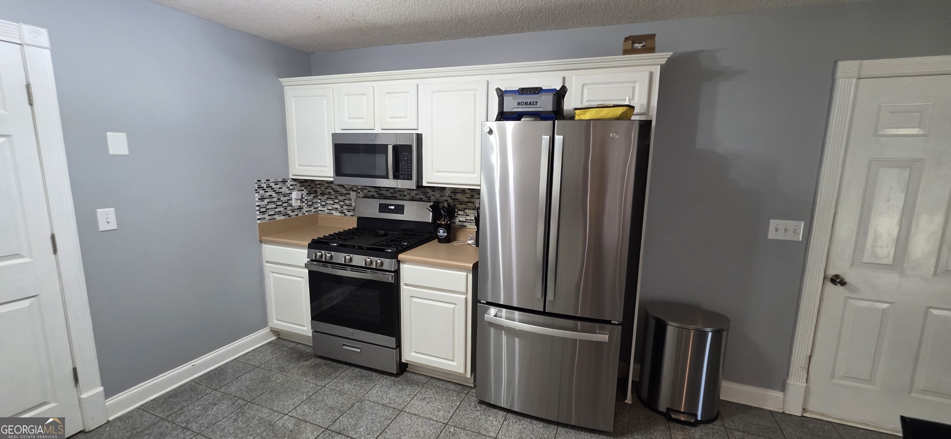 140 Villa Rosa Road Temple, GA 30179 - Photo 8 of 22 a kitchen with stainless steel appliances granite countertop a refrigerator and a stove top oven