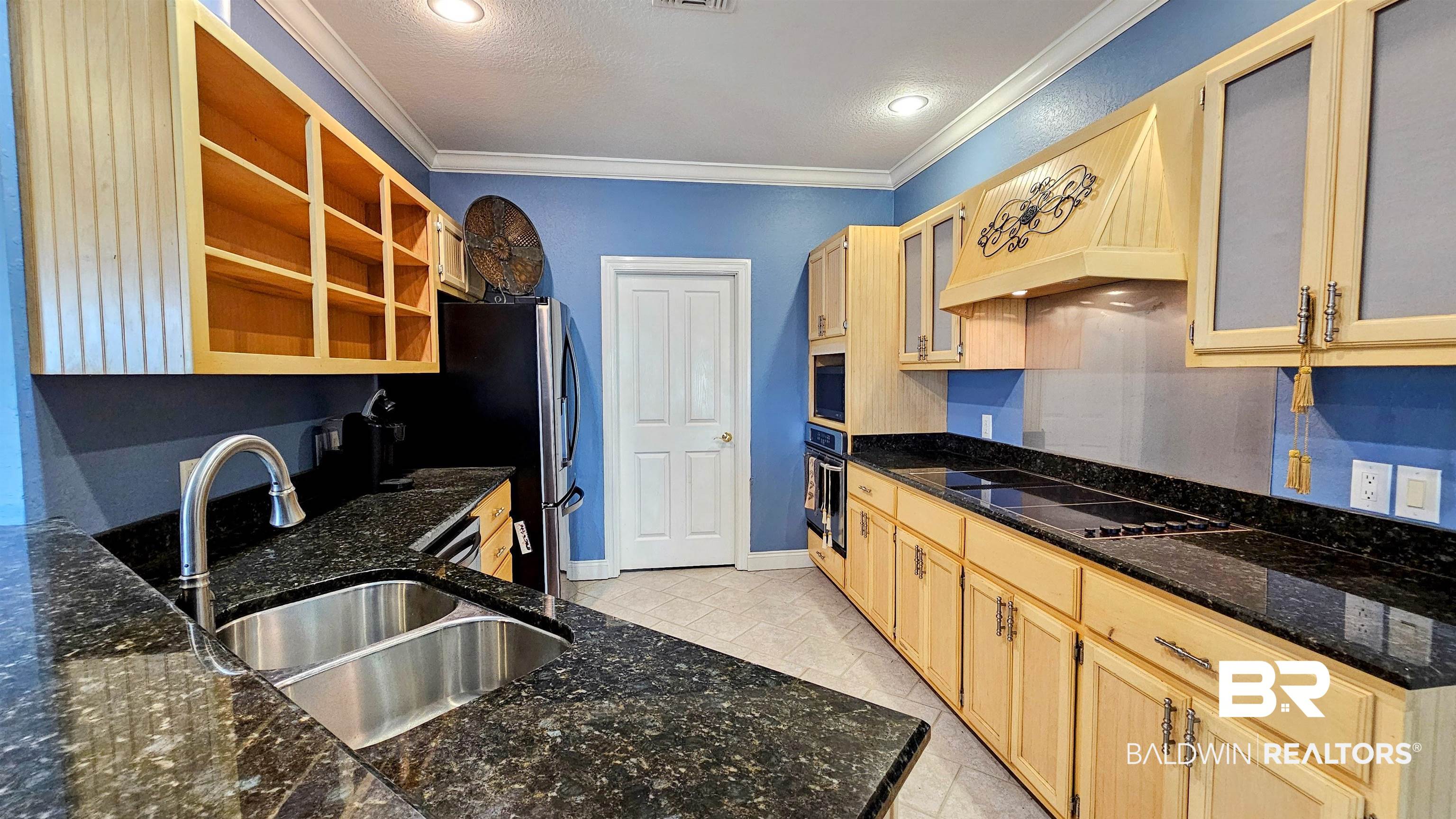 9275 Crawford Road Elberta, AL 36530 - Photo 22 of 28 Kitchen with crown molding, light brown cabinetry, custom exhaust hood, dark stone counters, and recessed lighting