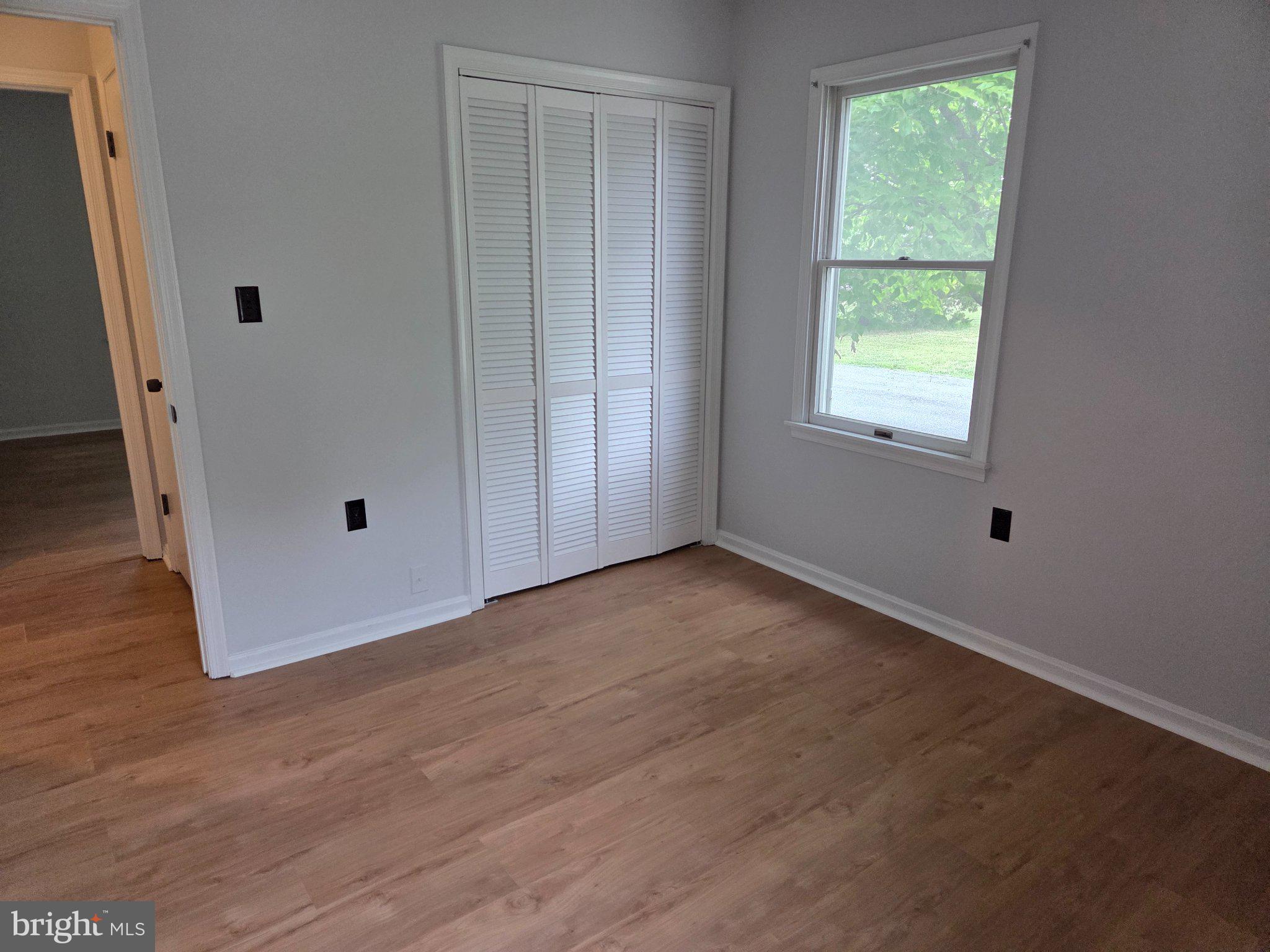 1378 Woodlytown Road Magnolia, DE 19962 - Photo 9 of 15 an empty room with wooden floor and windows