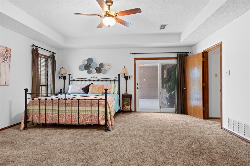 5840 Crystal Drive Midlothian, TX 76065 - Photo 21 of 36 a bedroom with a bed and a chandelier