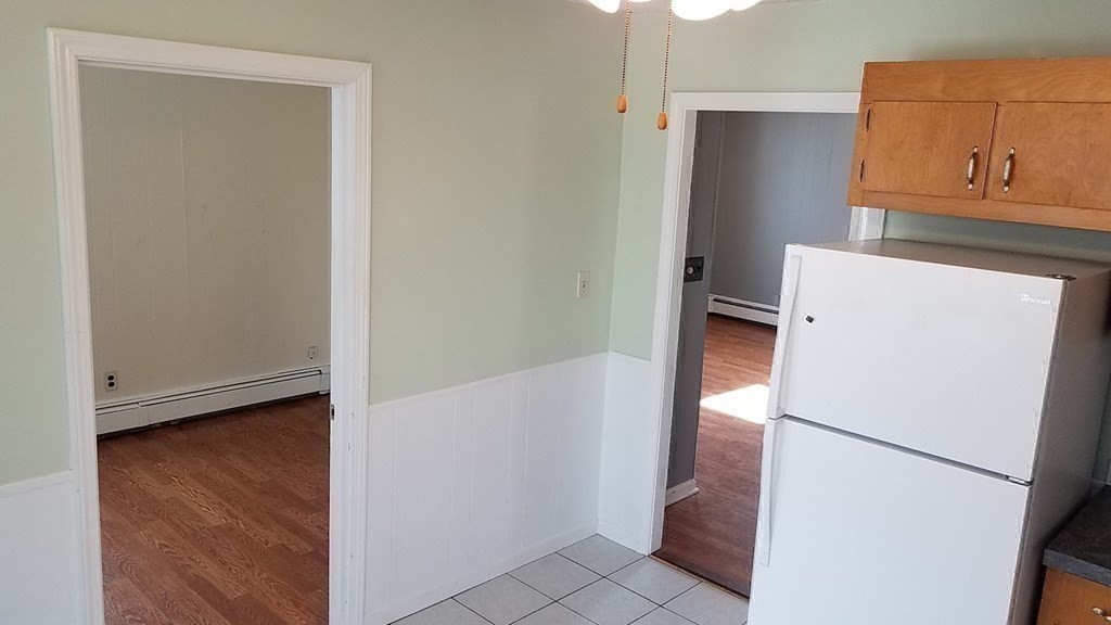 38-40 Pleasant Street Reading, MA 01867 - Photo 18 of 25 a white refrigerator freezer and a stove sitting inside of a kitchen
