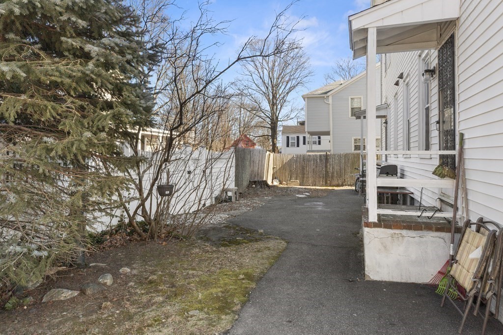 38-40 Pleasant Street Reading, MA 01867 - Photo 19 of 25 a view of a house with a yard